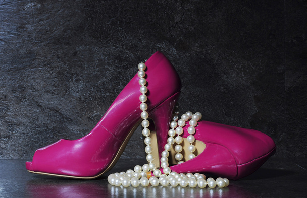 Ladies pink high heels with long strand of white pearls  - Photo, Image