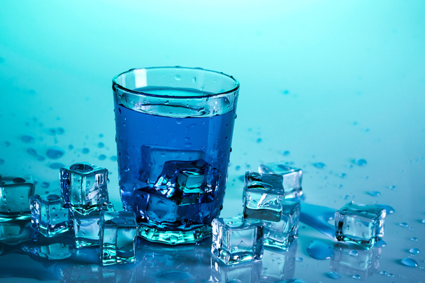 Glass with water on blue - Photo, Image