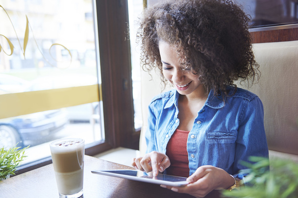 Girl using digital tablet in cafe - Photo, Image