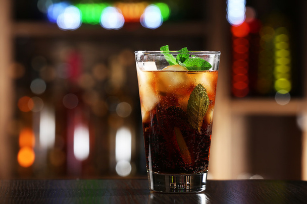 Glass of cocktail in bar on bright blurred background - Photo, image