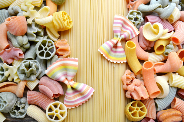 Set of different kinds of colorful Italian pasta on wooden table - Photo, Image