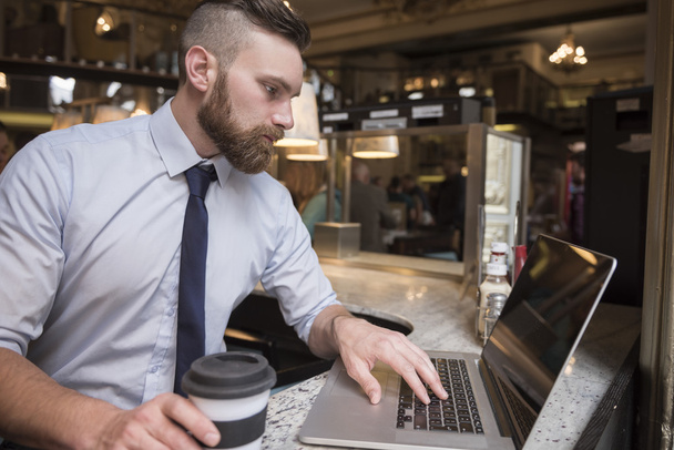 Успешный бизнесмен с ноутбуком в кафе
 - Фото, изображение