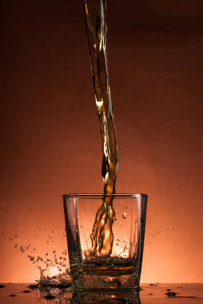 Whiskey splash in a glass - Valokuva, kuva