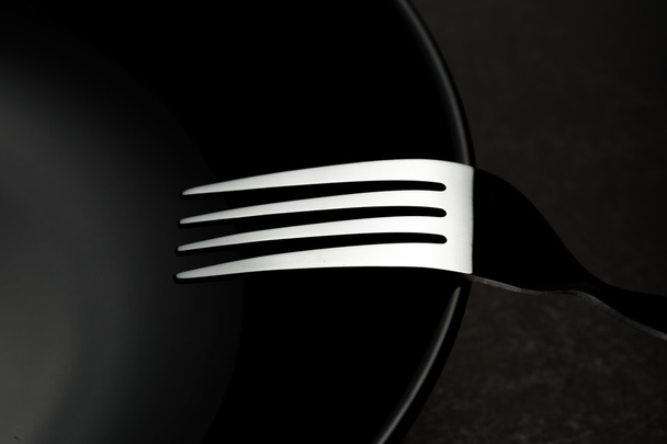 forks and black dish - Φωτογραφία, εικόνα
