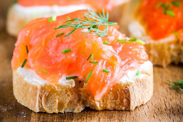 Appetizer canape of baguette with smoked salmon closeup - Фото, зображення