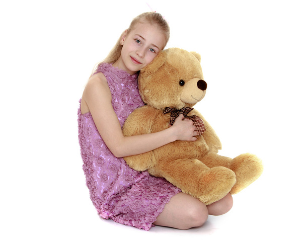 Blonde teen girl hugging a big Teddy bear - Foto, Imagen