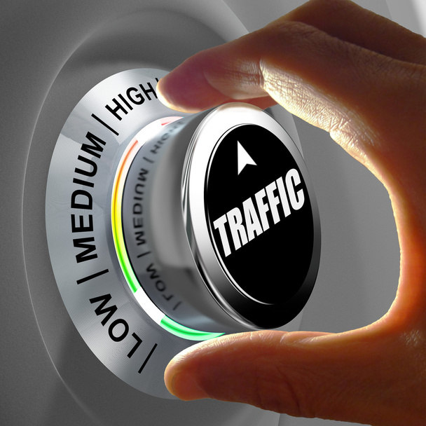 Hand rotating a button and selecting the level of traffic. - Photo, Image