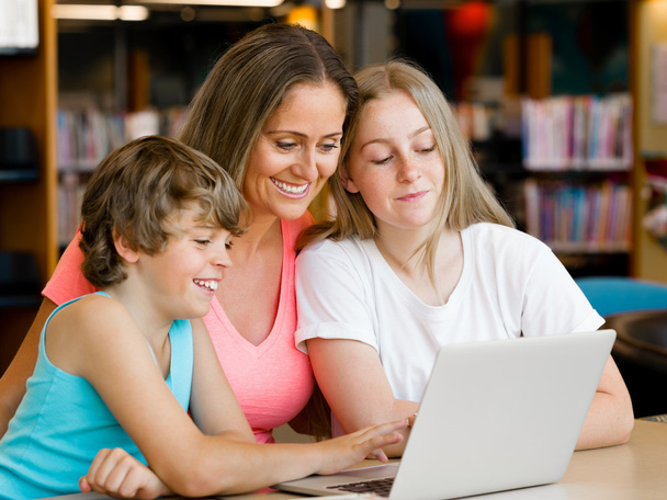 Mother with kids in library - Photo, Image