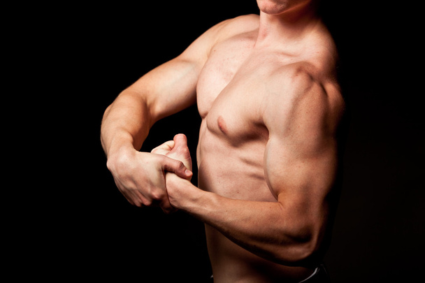 Man showing his muscles - 写真・画像