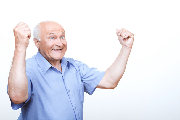 Laughing grandfather holding hands up - Fotó, kép