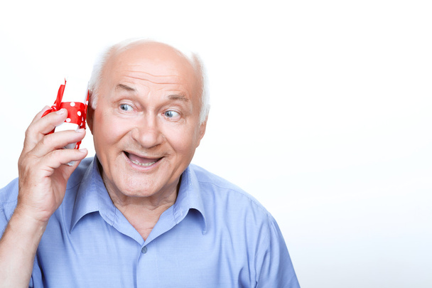 Positive grandfather holding the present  - Zdjęcie, obraz