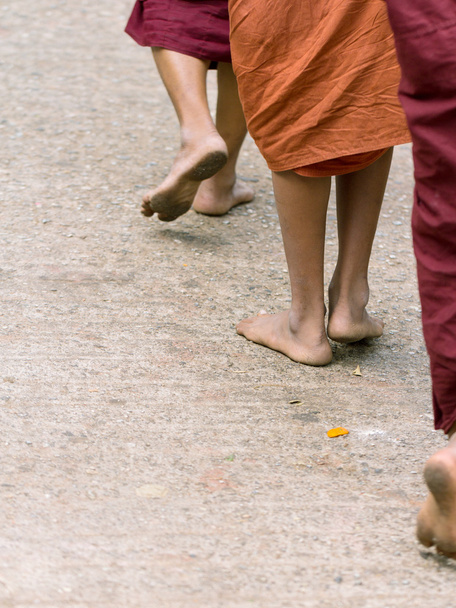 Foots of ascetic Buddhist monk walking at the way to  Kyaikhtiyo - Photo, Image