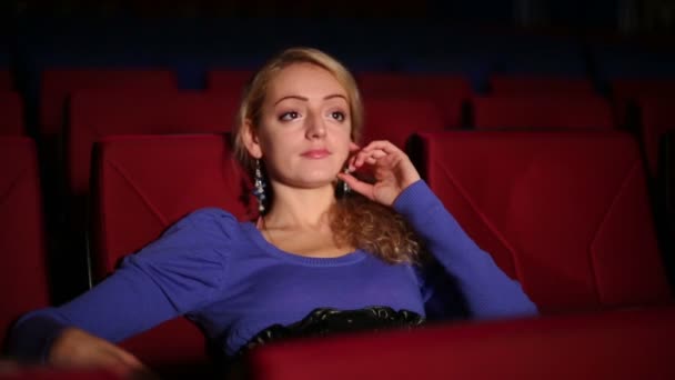 Young cute girl seats in cinema - Footage, Video