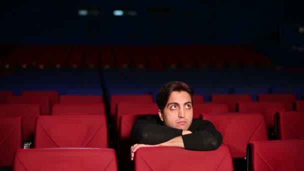 Young man seats in cinema hall - Footage, Video