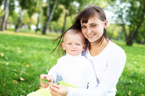 Young mother with her son in summer park - Foto, imagen