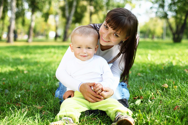 Young mother with her son in summer park - Foto, imagen