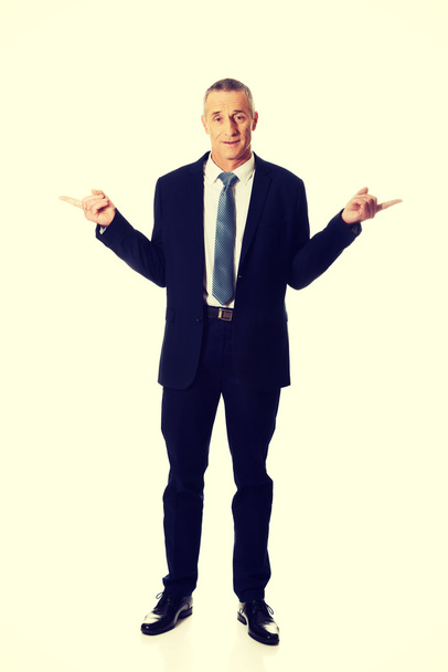 Full length businessman with hands on both sides - Foto, afbeelding