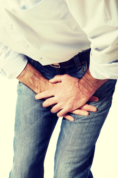 Close up on a man covering his painful crotch - Φωτογραφία, εικόνα