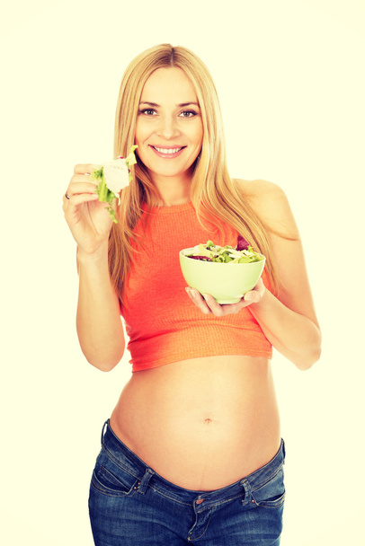 Pregnant woman eating a salad - Фото, зображення