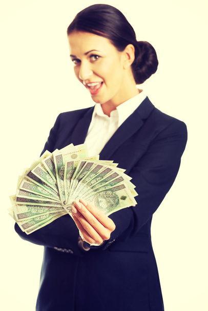 Businesswoman holding a clip of polish money - Foto, afbeelding