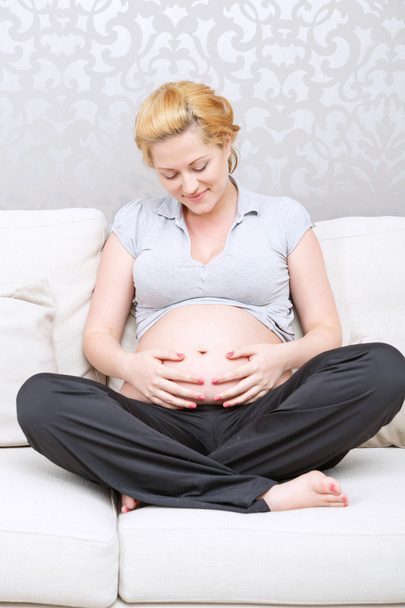 Pregnant smiling woman relaxing  - Fotografie, Obrázek