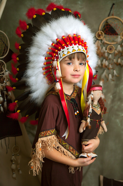 Baby girl in the national Indian clothes headdress of feathers w - Photo, Image