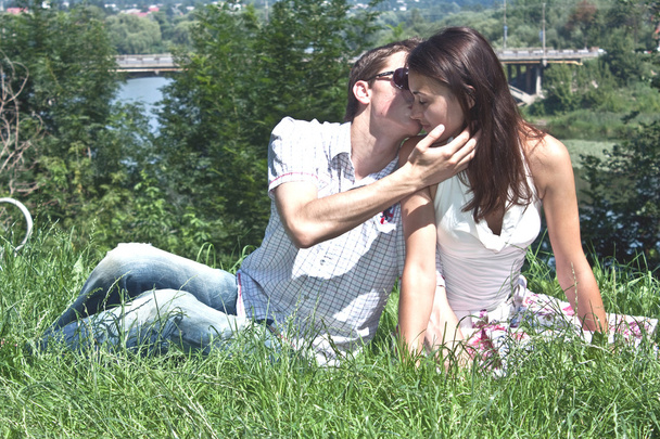 schöner Mann und die Frau küssen sich am Fluss in der Sonne - Foto, Bild