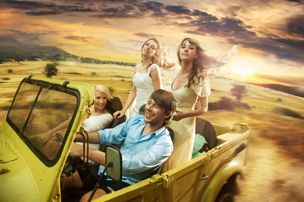 Group of cheerful friends driving a cabriolet - 写真・画像