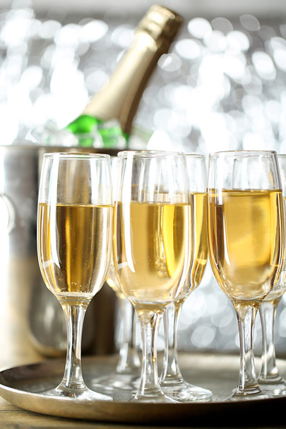 Glasses of champagne on bright background - Foto, imagen