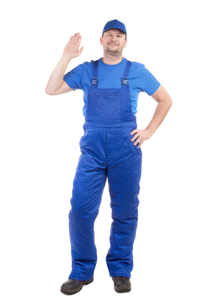 Worker in blue overalls. - Фото, изображение
