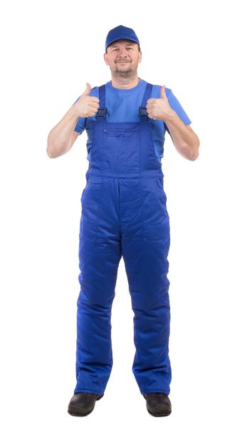 Worker in blue overalls.  - Valokuva, kuva