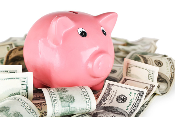 Piggy bank on pile of dollars, closeup - Fotó, kép