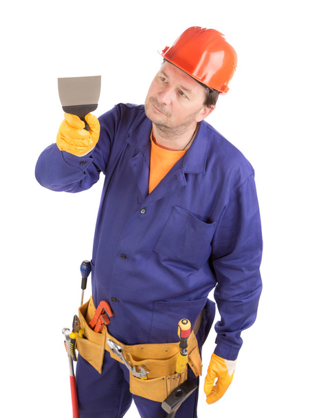 Worker in hard hat holding spatula. - Фото, зображення
