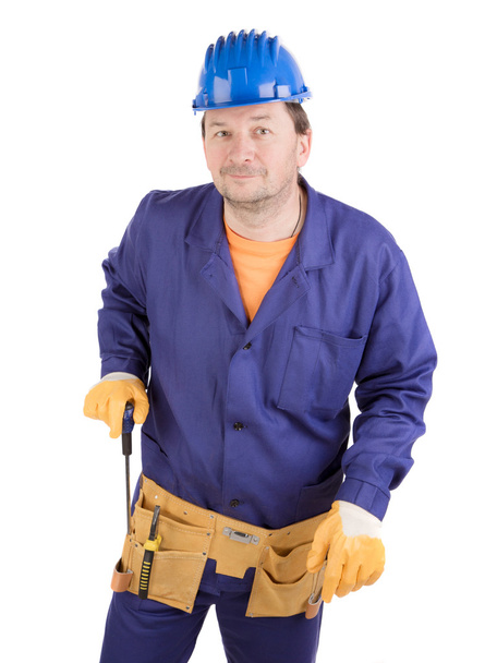 Pracovník v čepice drží šroubovák. - Fotografie, Obrázek