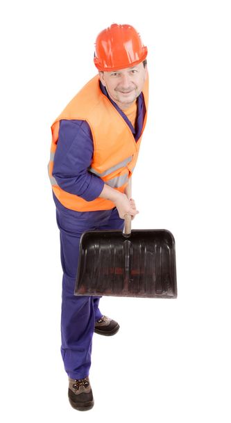 Worker in hard hat holding shovel. - Фото, изображение