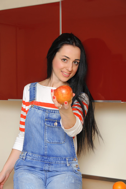 Girl in casual clothes holds a red apple  - Foto, immagini