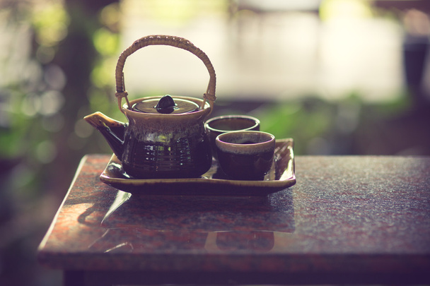 cup of black tea with teapot  - Photo, Image