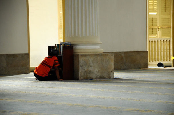 A boy reading Quran in Sultan Abu Bakar State Mosque in Johor Bharu, Malaysia - Photo, Image