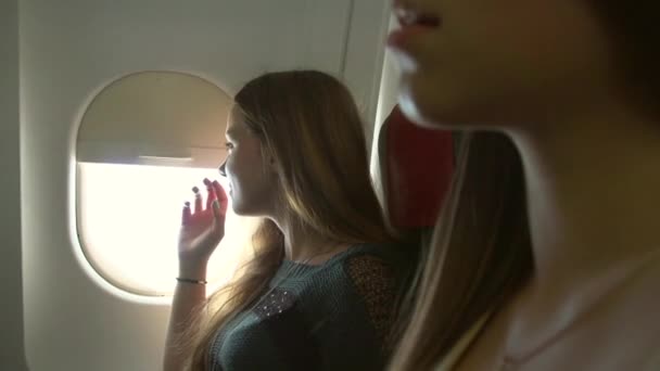 Young women traveling by plane - Footage, Video