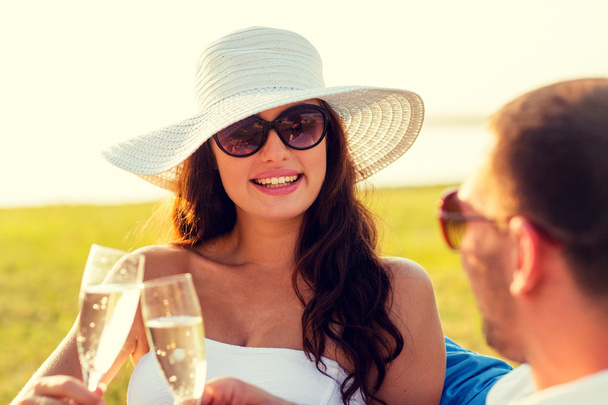 smiling couple drinking champagne on picnic - Fotó, kép