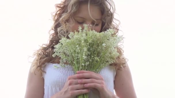 girl with bunch of wild flowers - Filmati, video