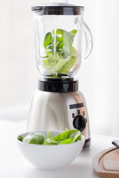 close up of blender jar and green vegetables - Zdjęcie, obraz
