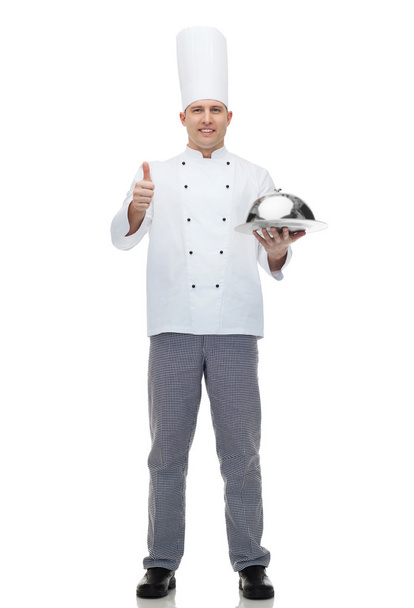 happy male chef cook with cloche showing thumbs up - Foto, Imagen