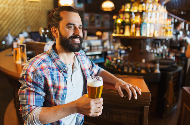 happy man drinking beer at bar or pub - Photo, Image