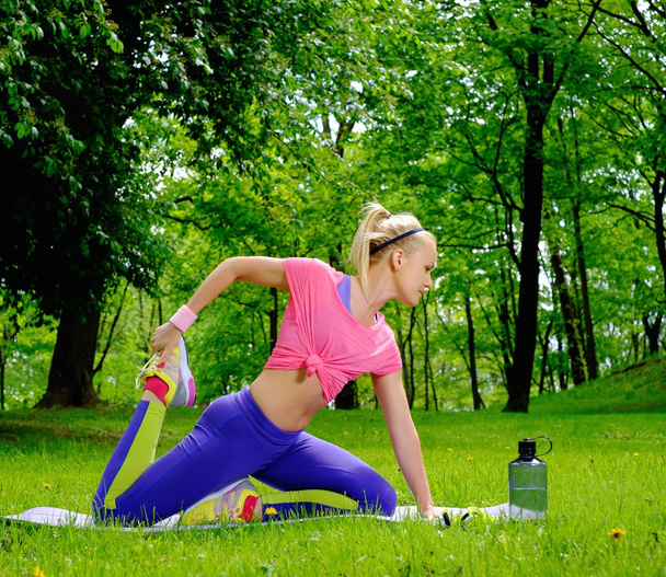 Mujer deportiva haciendo ejercicios de fitness al aire libre
 - Foto, Imagen