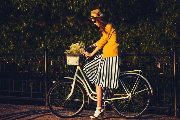 Young beautiful, elegantly dressed woman with bicycle. Beauty, fashion and lifestyle - Foto, Imagem