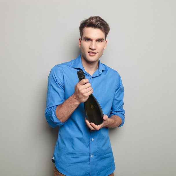 man holding a champagne bottle in his hands - Fotoğraf, Görsel