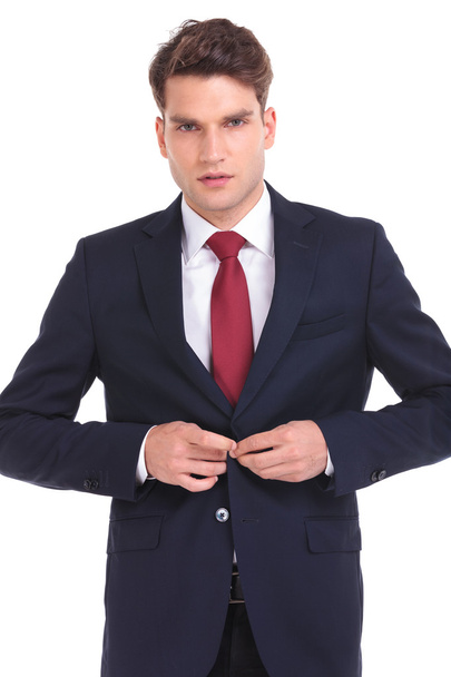Young business man closing his jacket  - 写真・画像