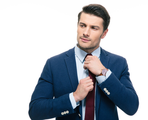 Handsome businessman straightening his tie  - Foto, Imagem