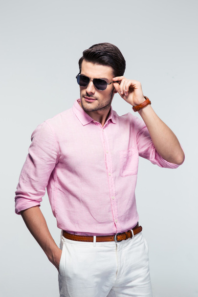 Portrait of a trendy young man in sunglasses - Photo, Image